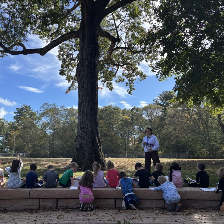 children sitting by a tree