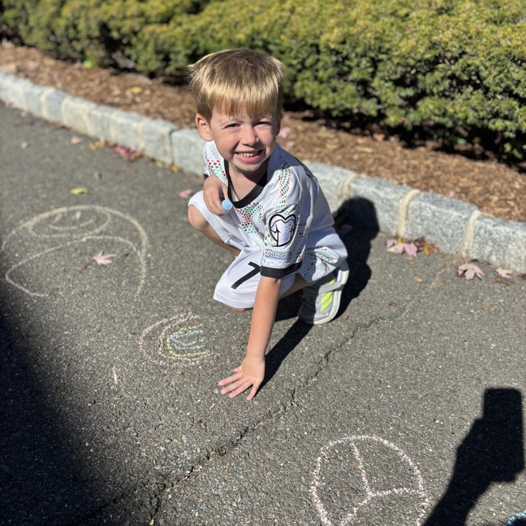 boy drawing a peace sign