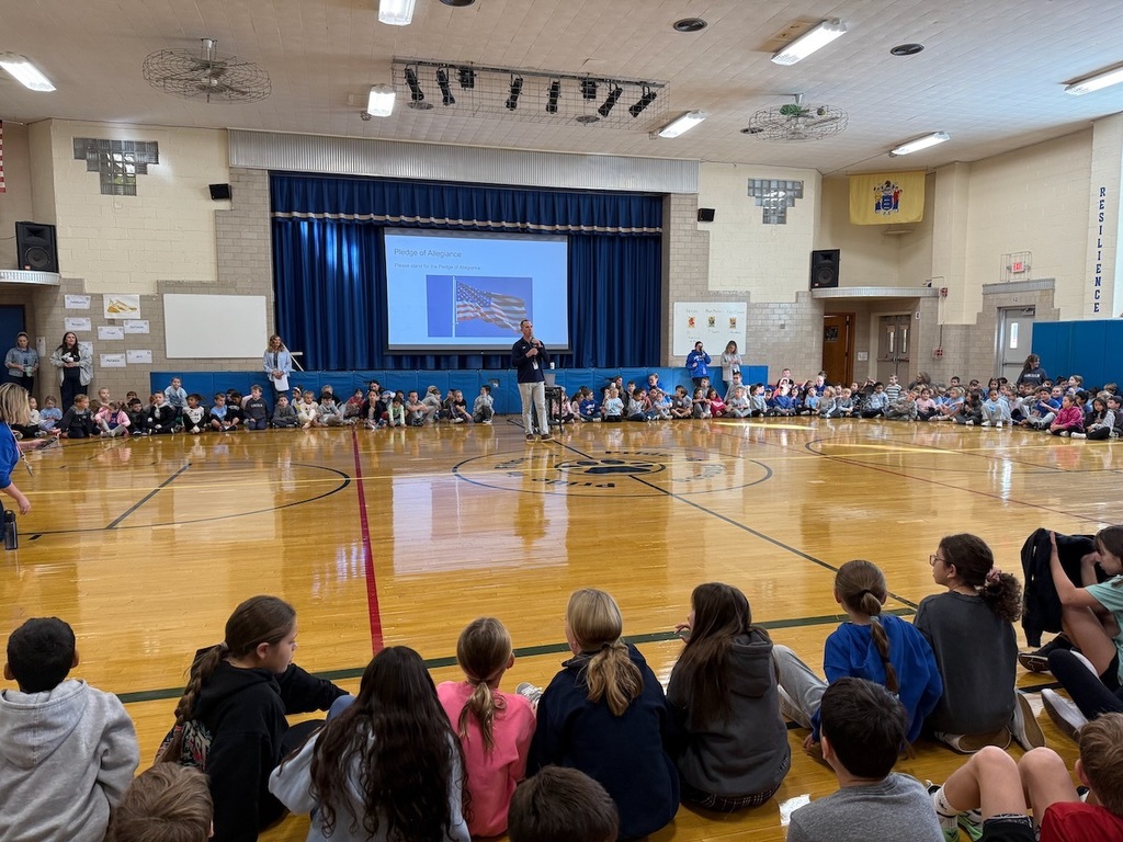 Students gathered in a circle in the school gym.
