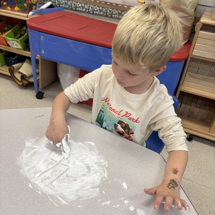boy writing in shaving cream