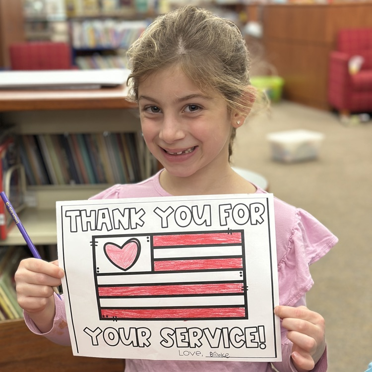 student holding Veterans Day picture