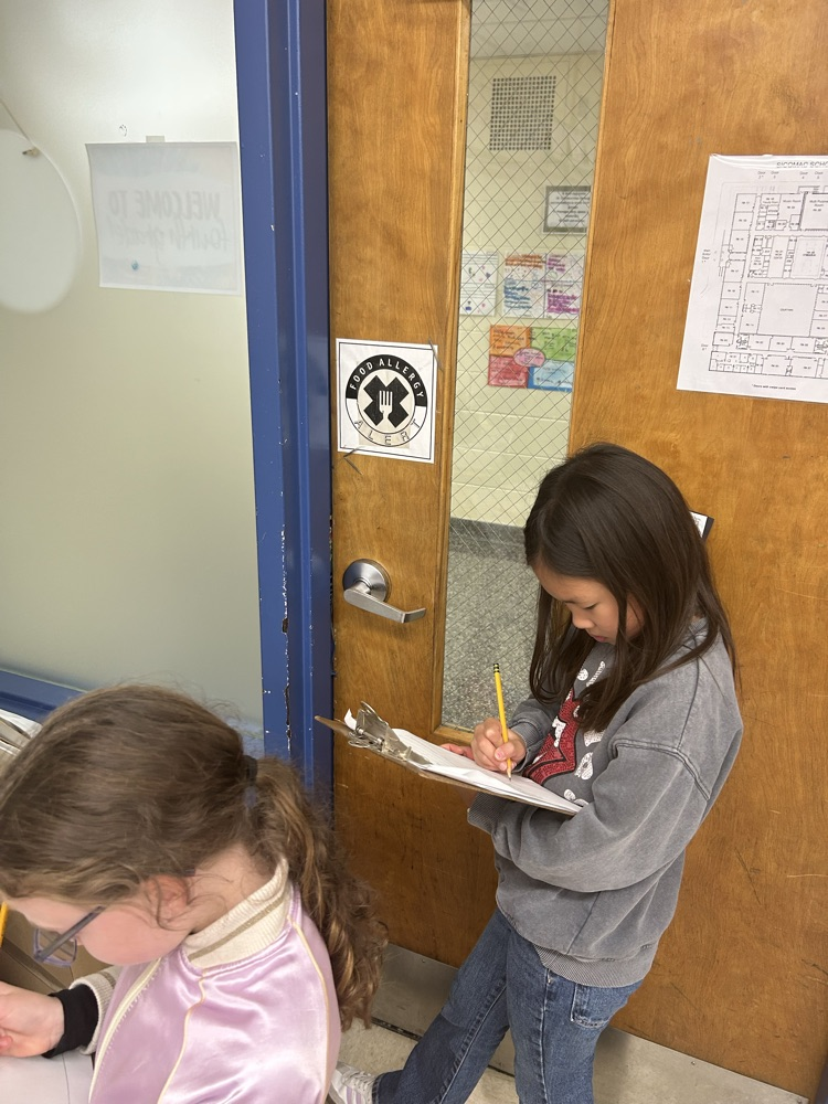 Students working around the room to solve math problems.
