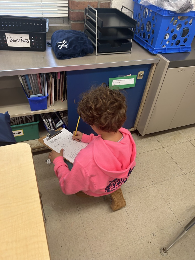Students working around the room to solve math problems.