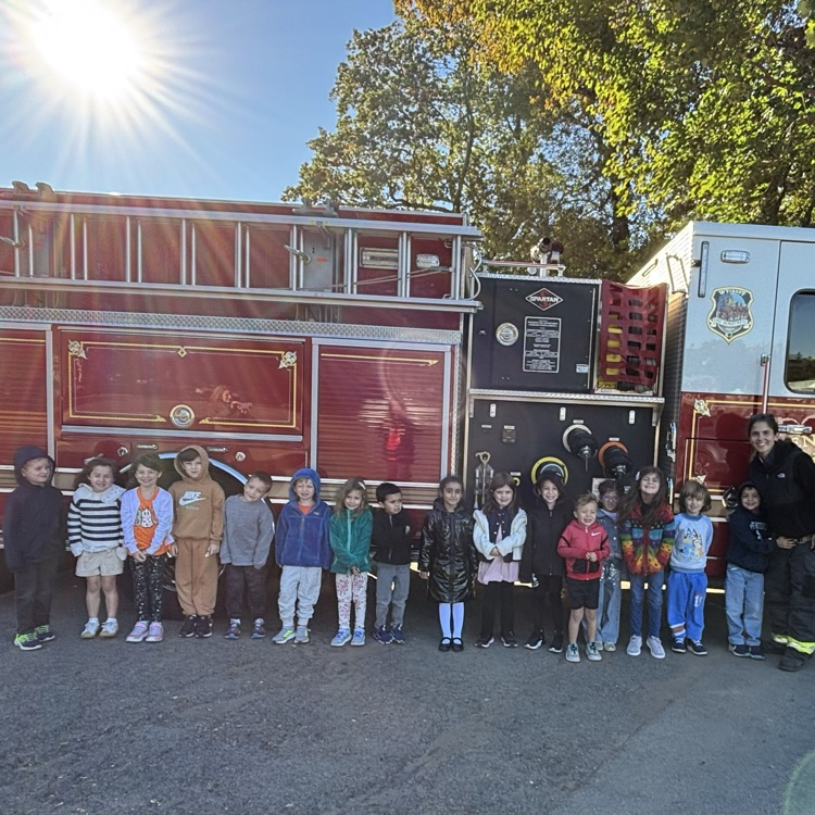children in front of a firetruck