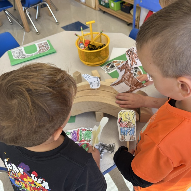 children using puppets to retell a story