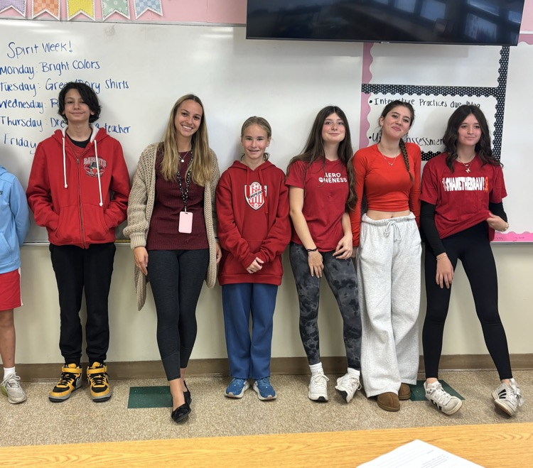 Students smiling in red outfits