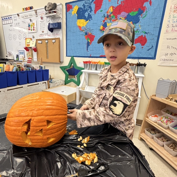 boy carving a pumpkin