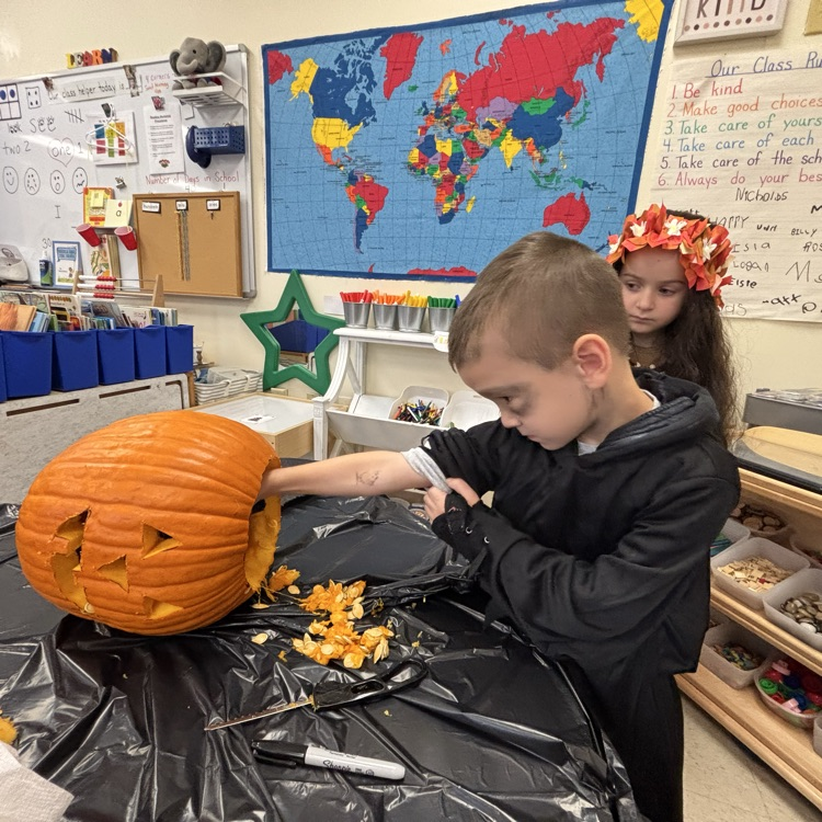 boy carving a pumpkin