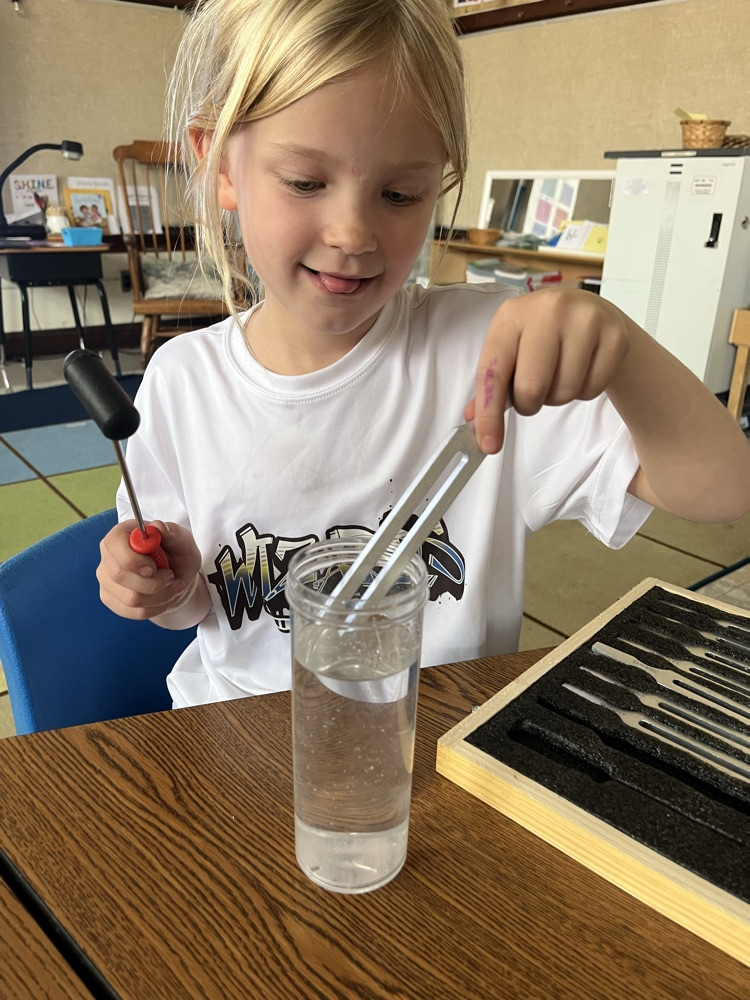 student experiments with a tuning fork