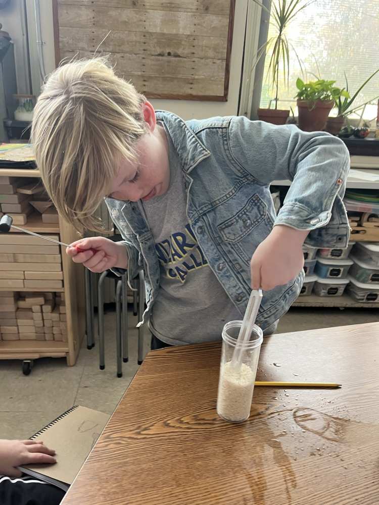 student experiments with a tuning fork