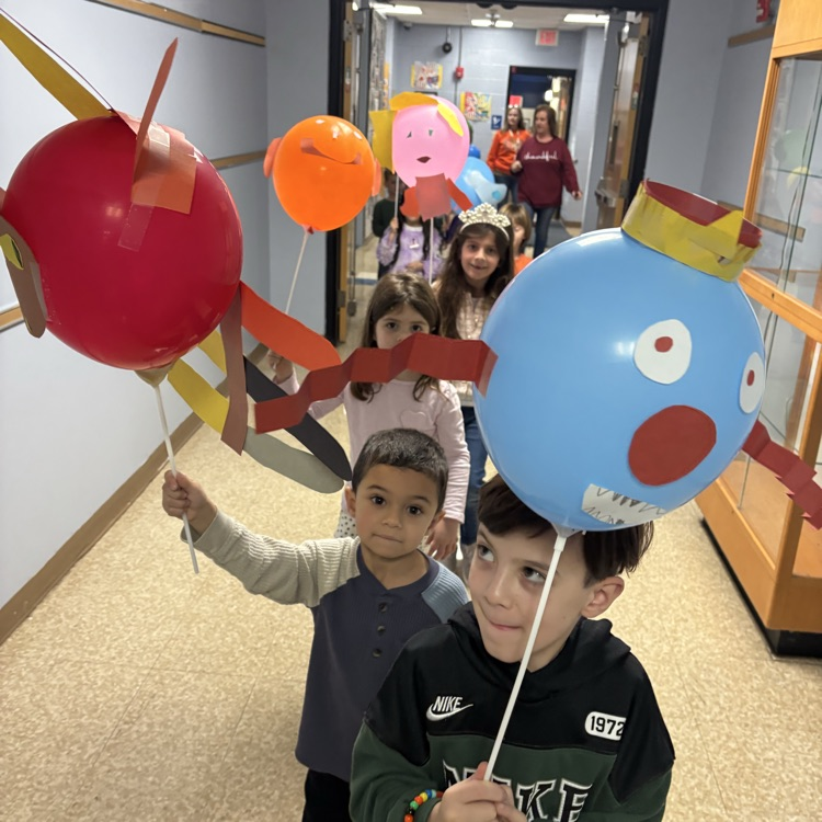 children carrying balloons
