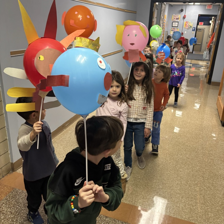Children carrying balloons