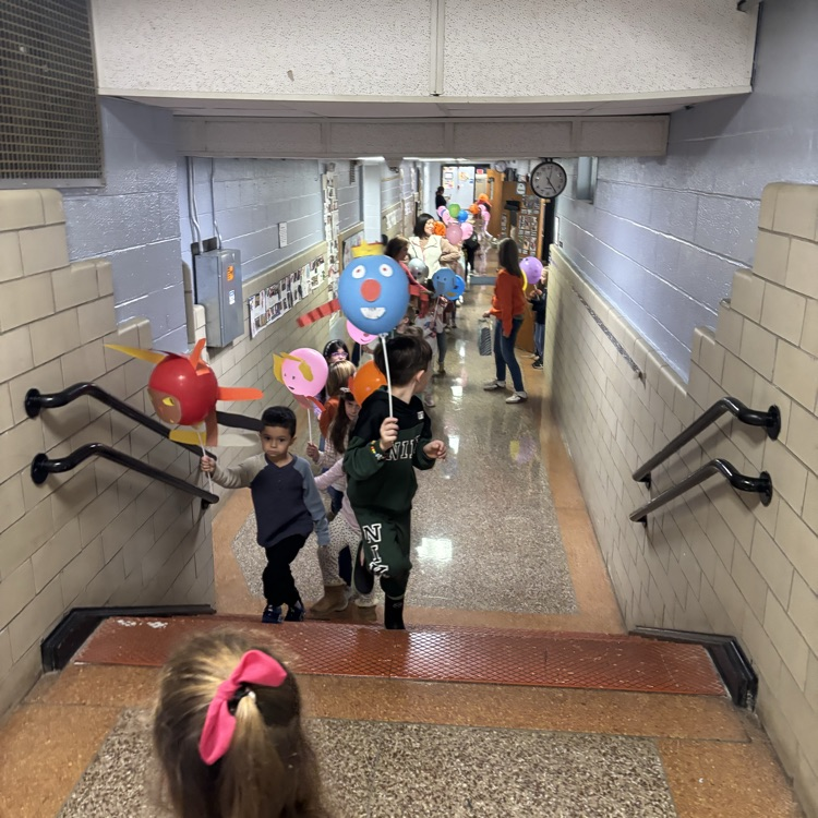 children carrying balloons