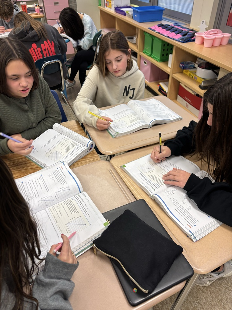 students working on practice problems in textbook 