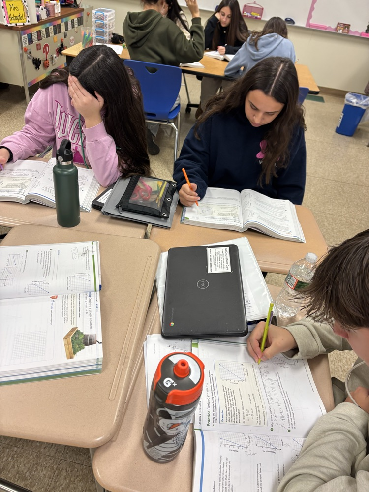 students working on practice problems in textbook