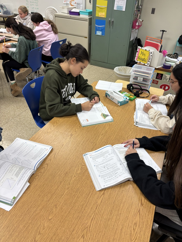 students working on practice problems in textbook