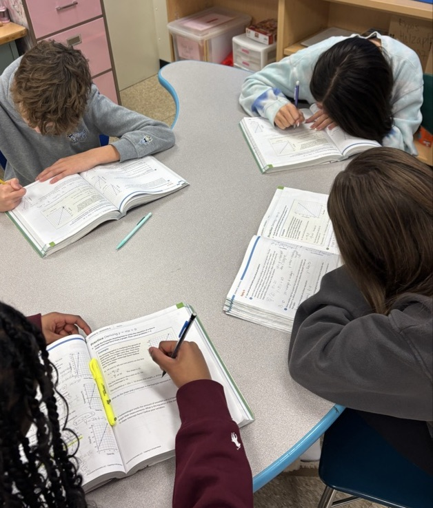 students working on practice problems in textbook
