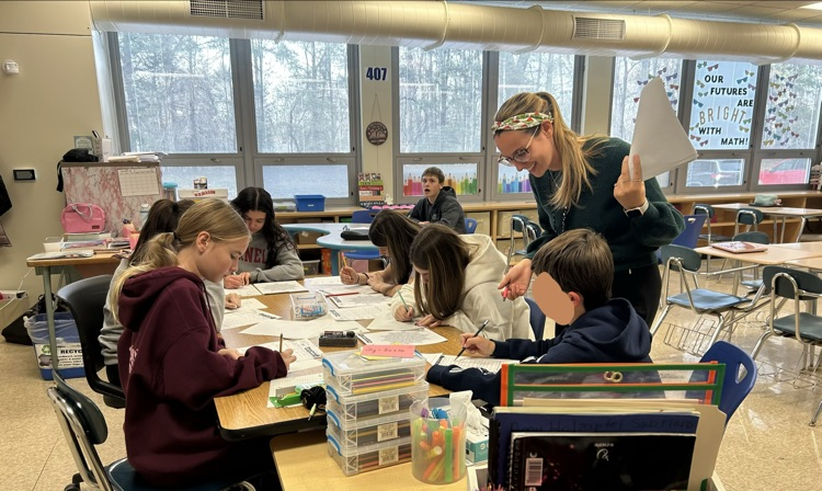 students working in a group at a back table
