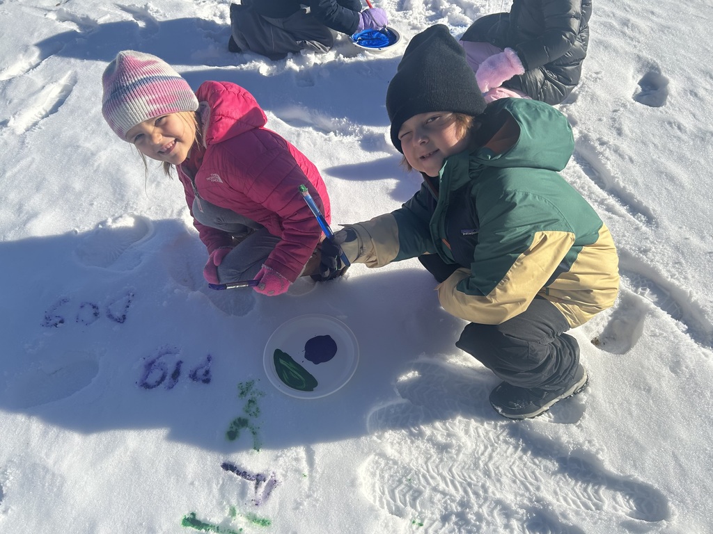 children  writing in the snow