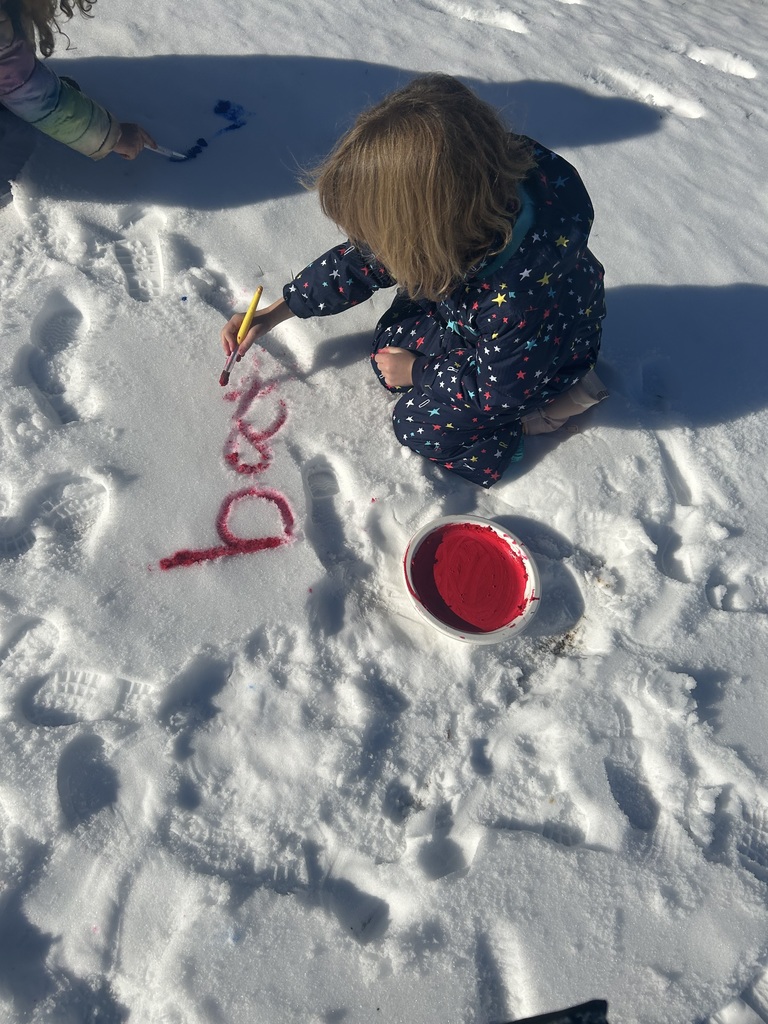 children  writing in the snow