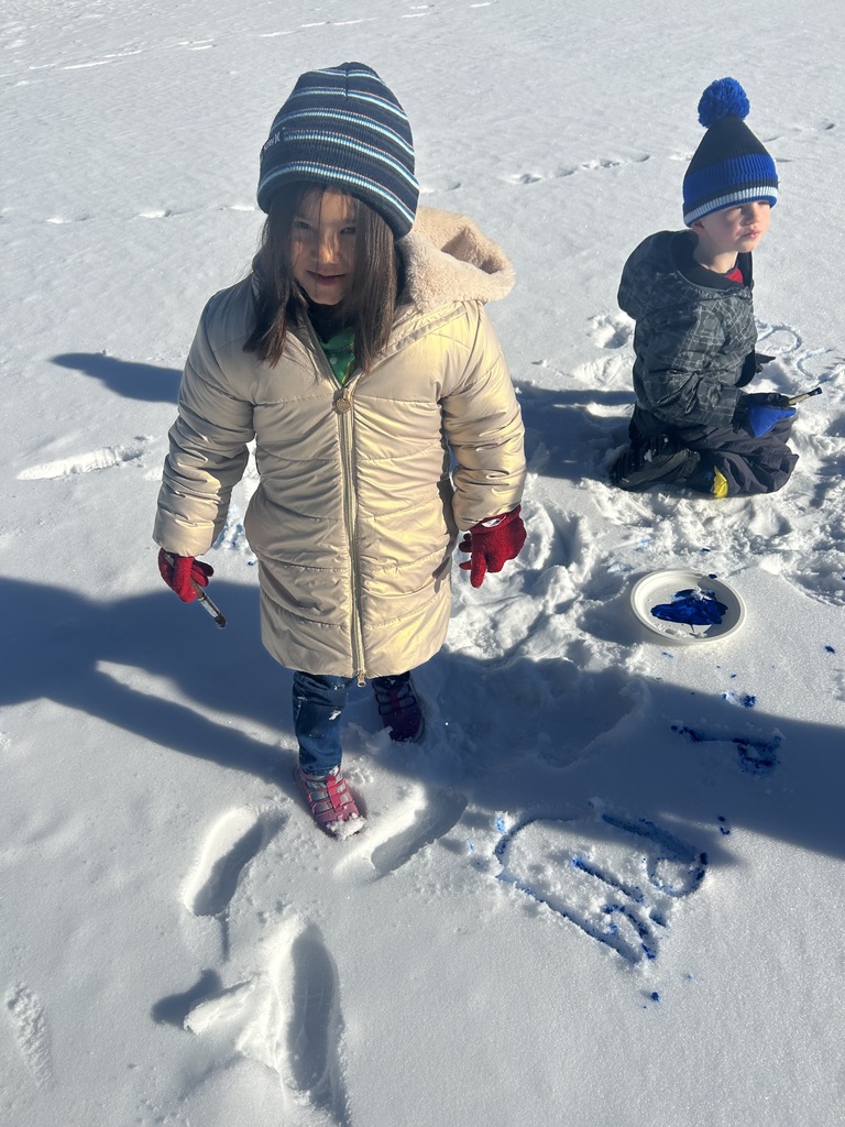 children  writing in the snow