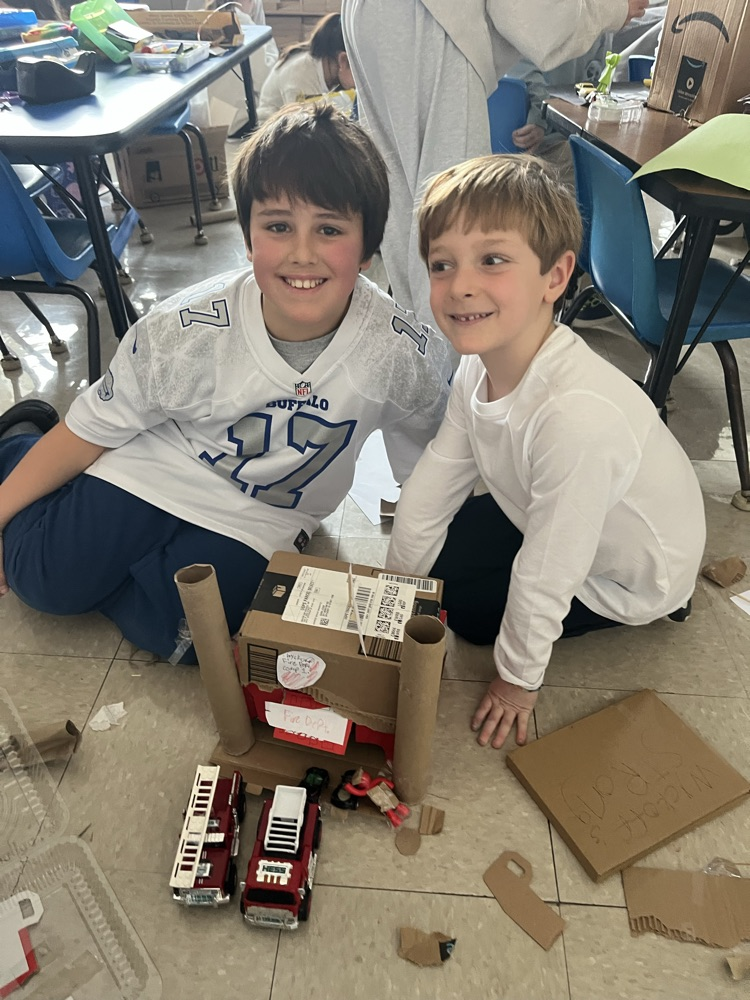 2 children with a model the created of the fire department