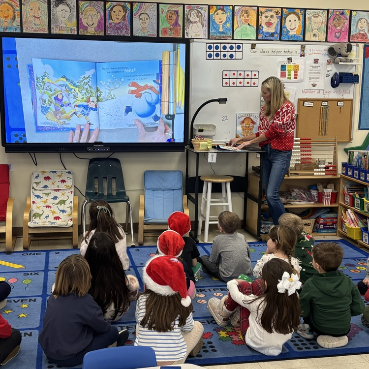 Parent reading a story to a class