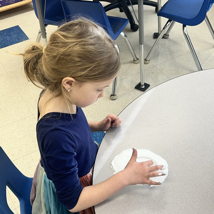 KRO practices letter formation and letter sounds by tracing in shaving cream.