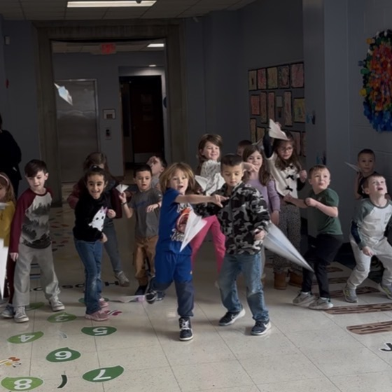 children flying paper airplane
