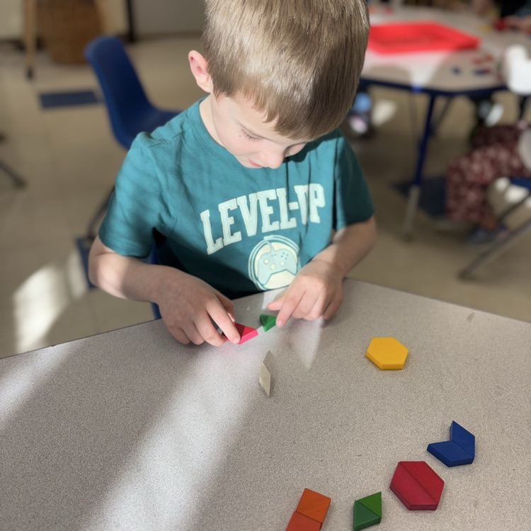 boy manipulating shapes