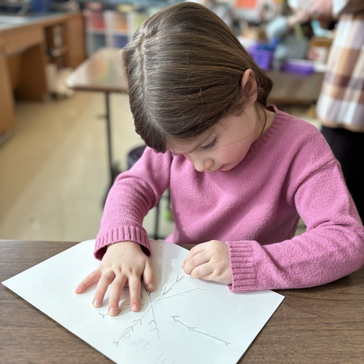 girl drawing snowflake