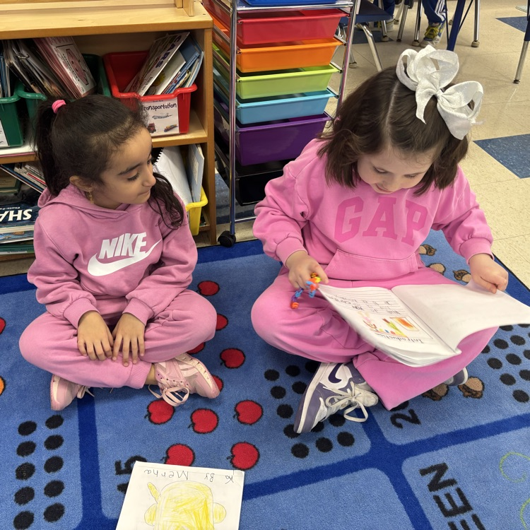 girls reading to one another