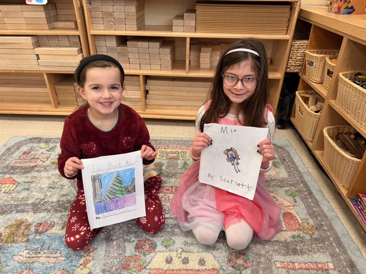 two student students sharing their writing books together