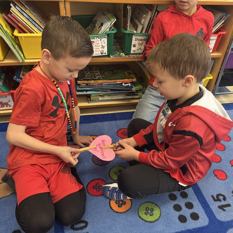 boys passing Valentine heart