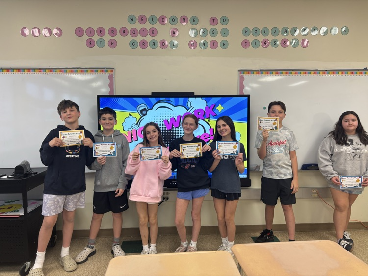 students holding up their certificates for solving the mystery  