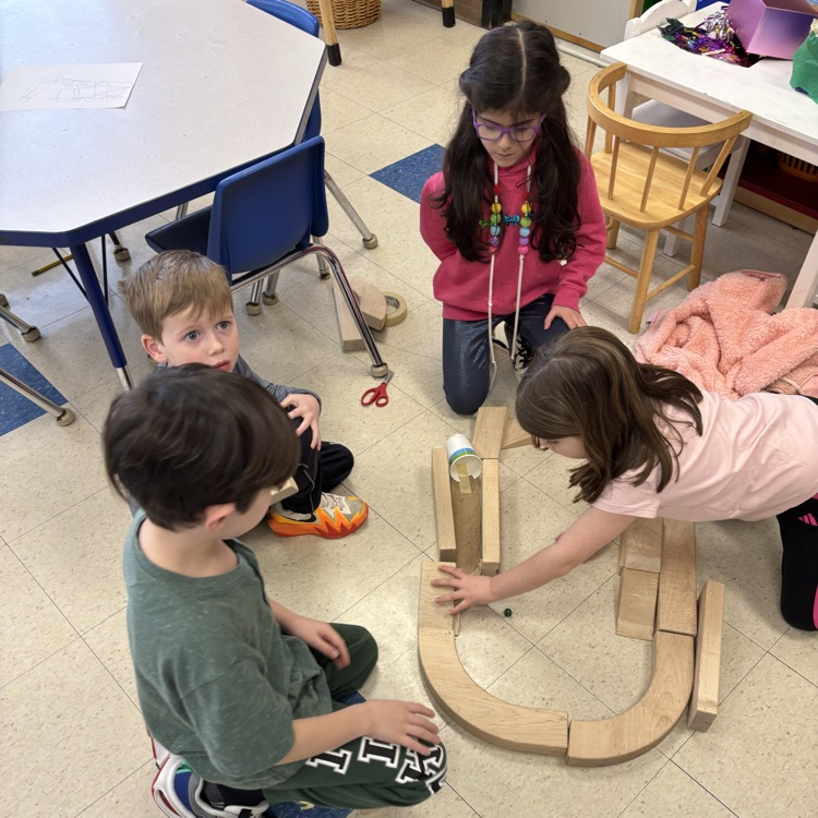 children creating a marble run out of blocks