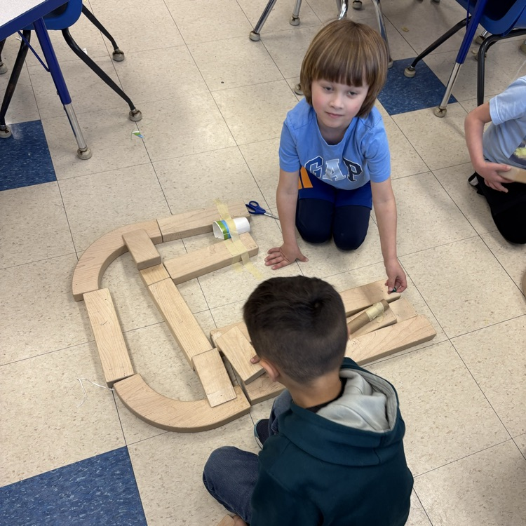 children creating a marble run out of block