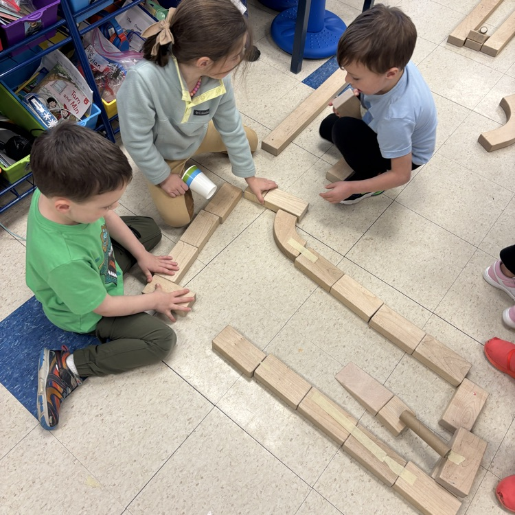 children creating a marble run out of blocks