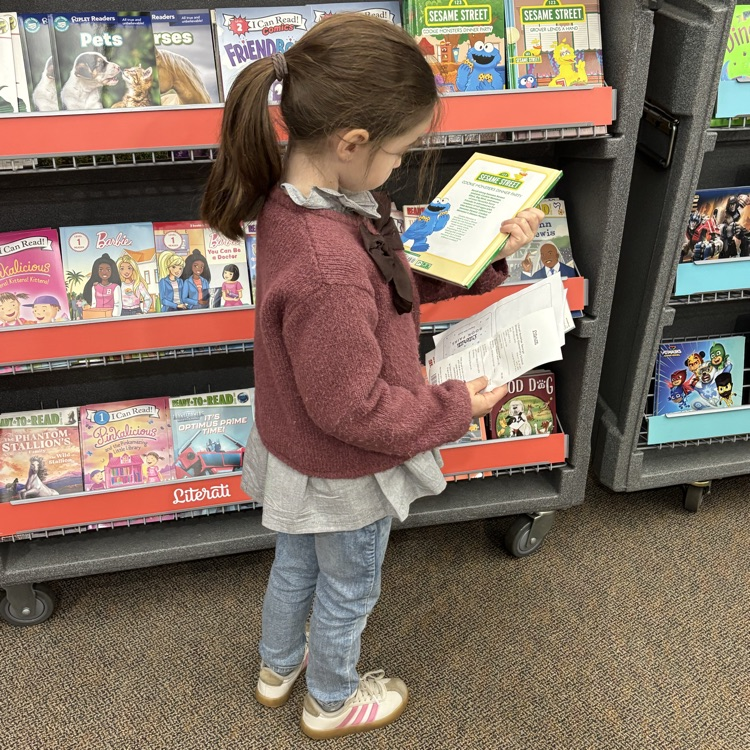 Little girl looking at books