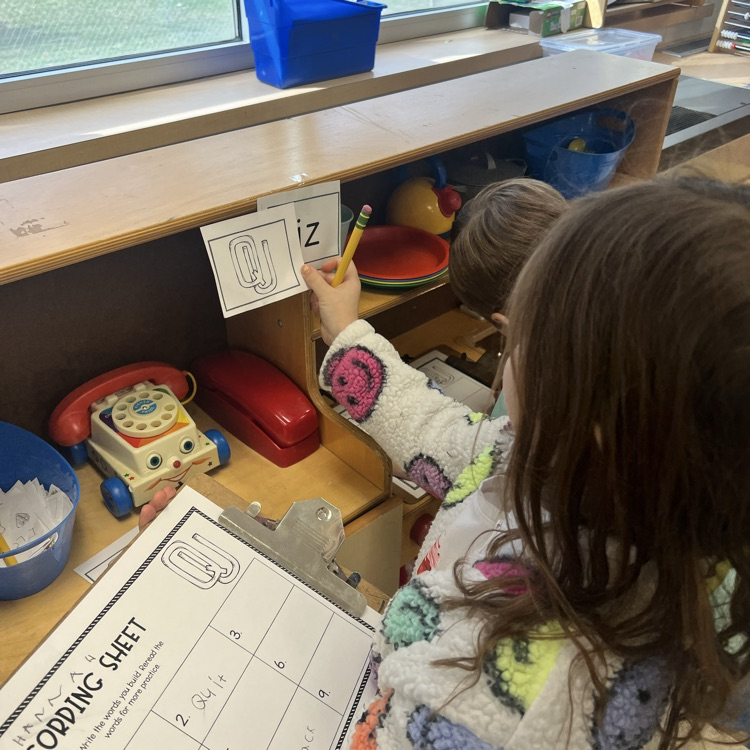 KRO uses QU to form words during a Write the Room activity 