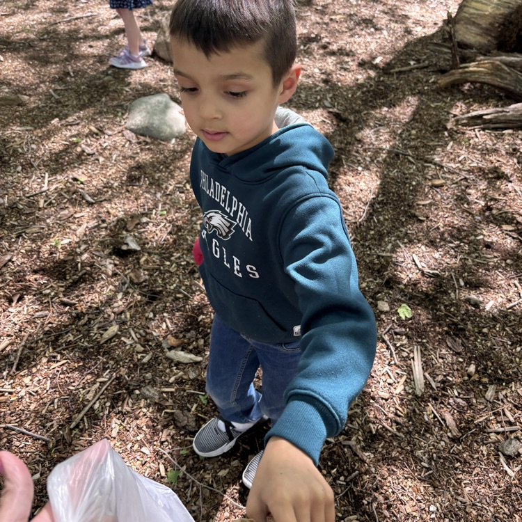 boy picking up garbage