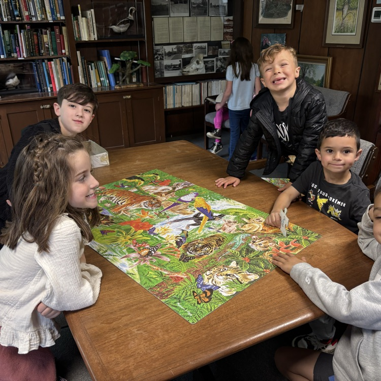 children around a puzzle