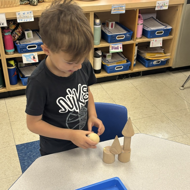 boy making a castle with solid shapes