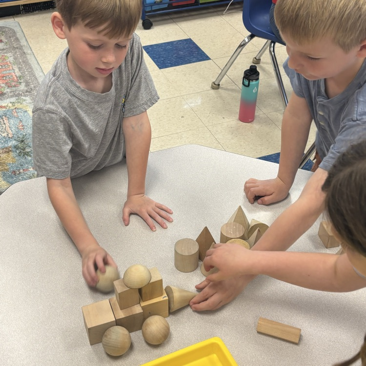 students working together to make a driller out of shapes