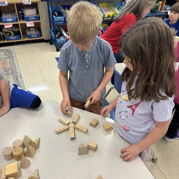students making a flower using solid shapes
