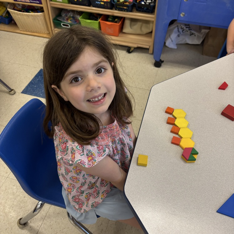 student making a picture with shapes