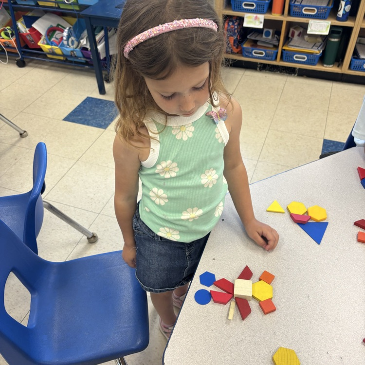 student making a picture with shapes