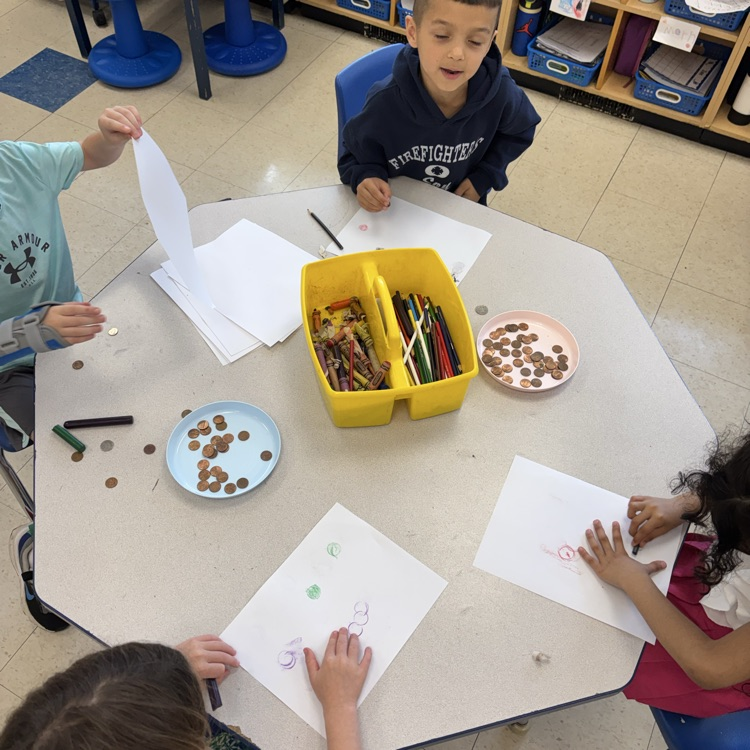 students doing coin rubbings