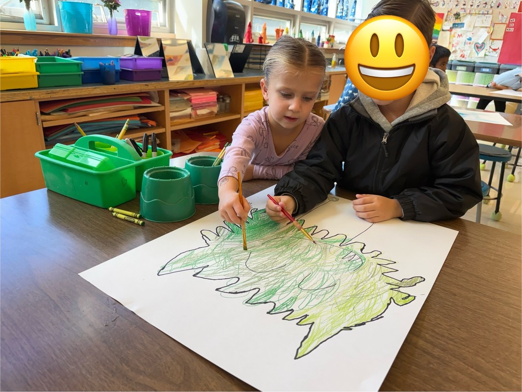 Two students painting together in the art room.
