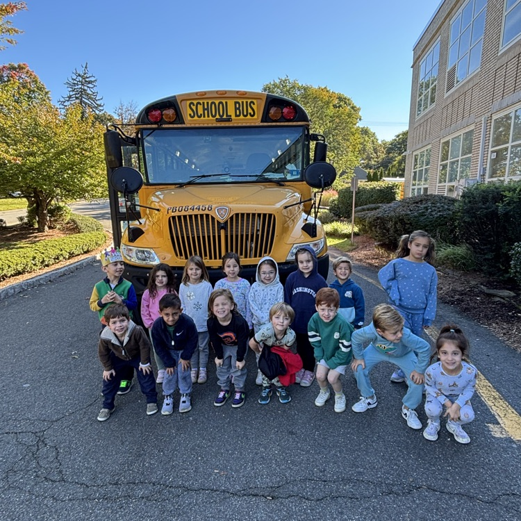 students in front of a school bus
